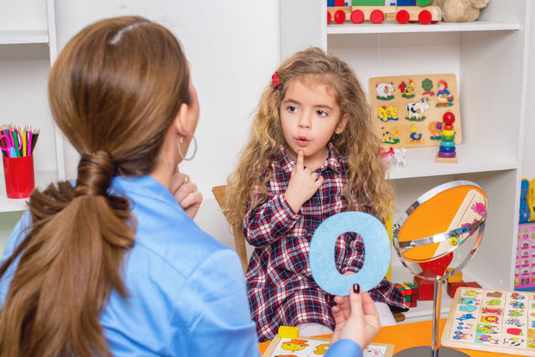 Young girl  in speech therapy office. 