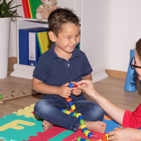 Shot of a speech therapist during a session with a little boy.