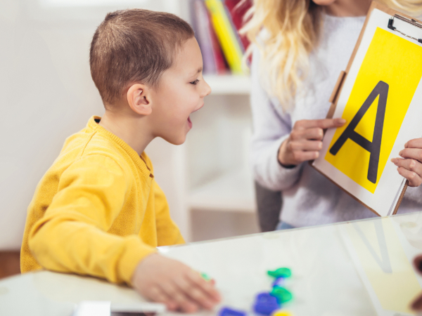 Speech therapist teaches the boys to say the letter A